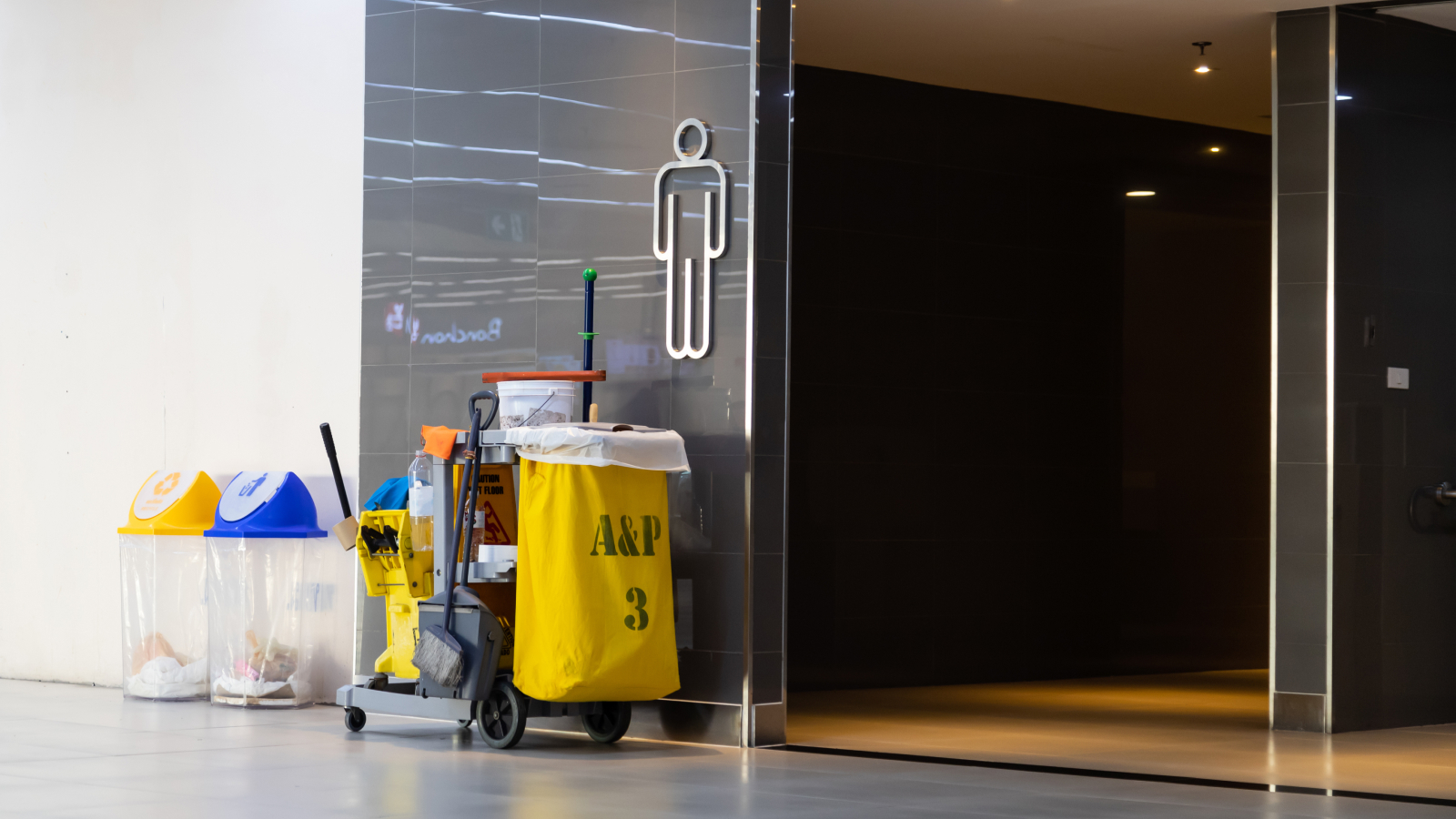 facility manager and cleaning staff inspecting a clean restroom, ensuring optimal hygiene standards